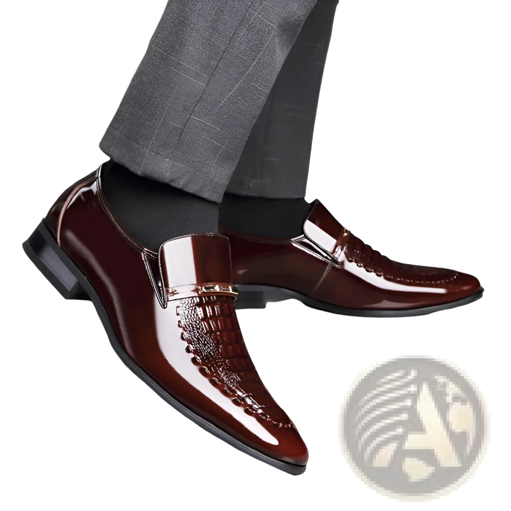 Polished burgundy crocodile patent leather men’s loafers with textured toe cap and metallic accent buckle