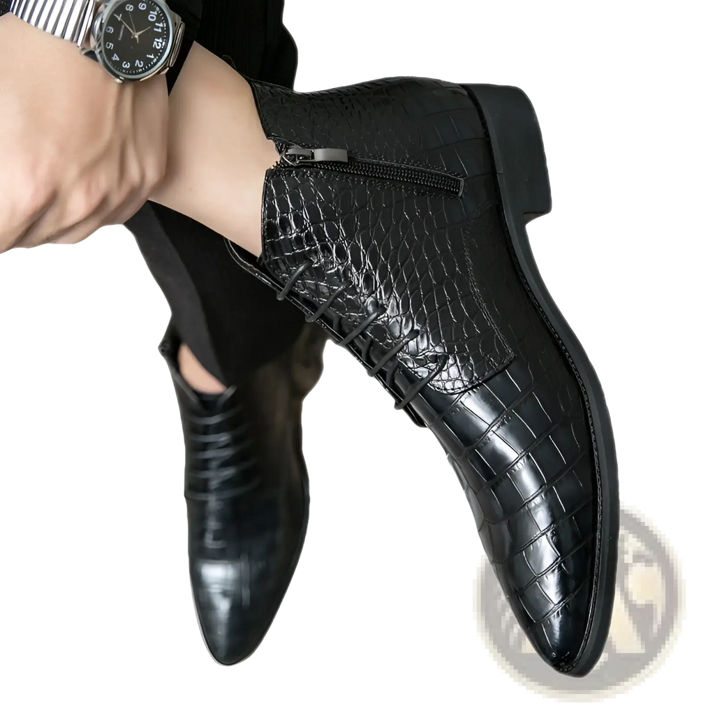 Black crocodile-patterned leather ankle boots with a sleek pointed toe and zipper closure