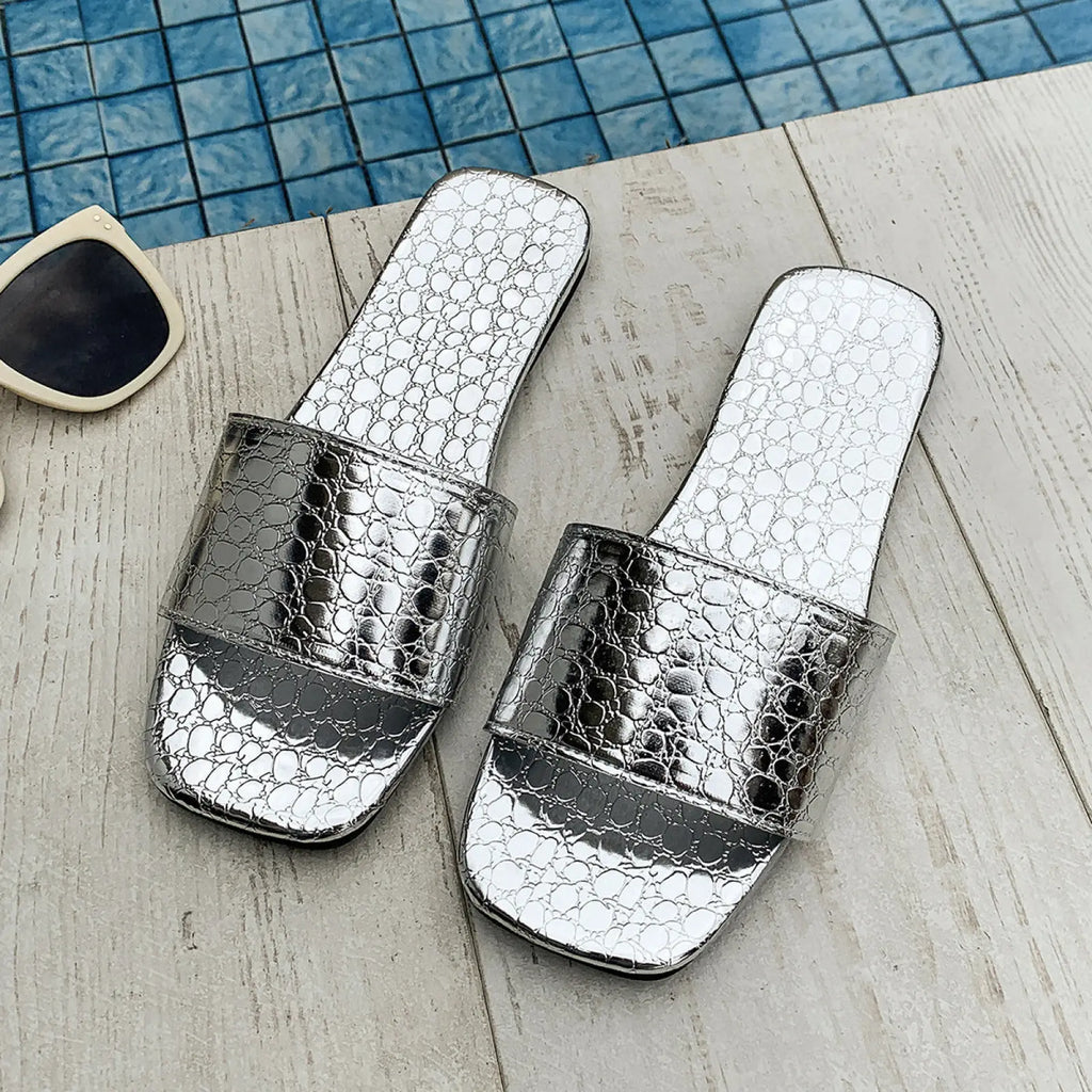 Silver crocodile textured square toe flat beach sandals with a glossy finish and slip on slide design
