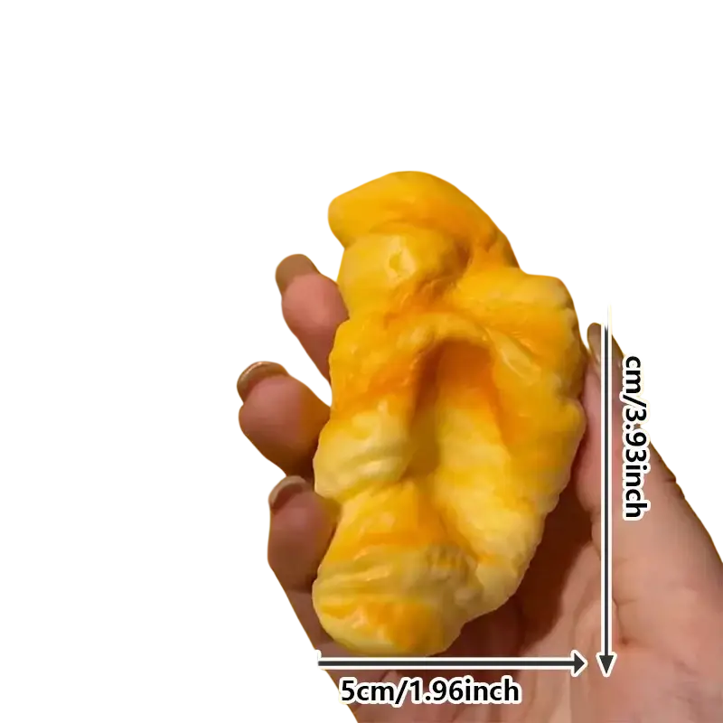 Golden-yellow flaky croissant squeeze toy with soft squishy texture for stress relief and sensory play