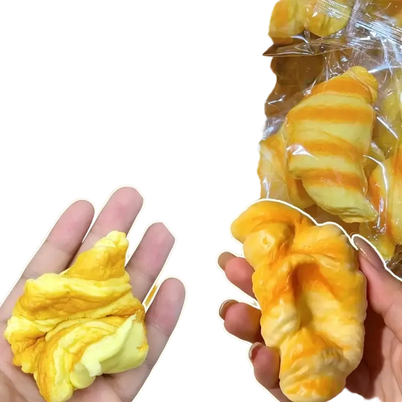 Yellow and orange striped croissant squeeze toy stress ball designed for stress relief and hand exercise