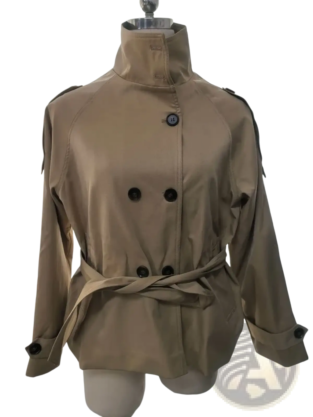 Beige cropped trench jacket with black buttons and belted waist displayed on a mannequin for autumn outerwear