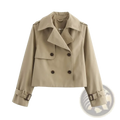 Beige double-breasted cropped trench jacket for women with dark brown buttons and adjustable belt cuffs for streetwear