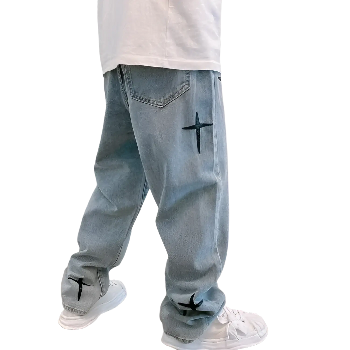 Back side of light-wash denim baggy wide leg jeans with black cross embroidery on pocket and cuffs