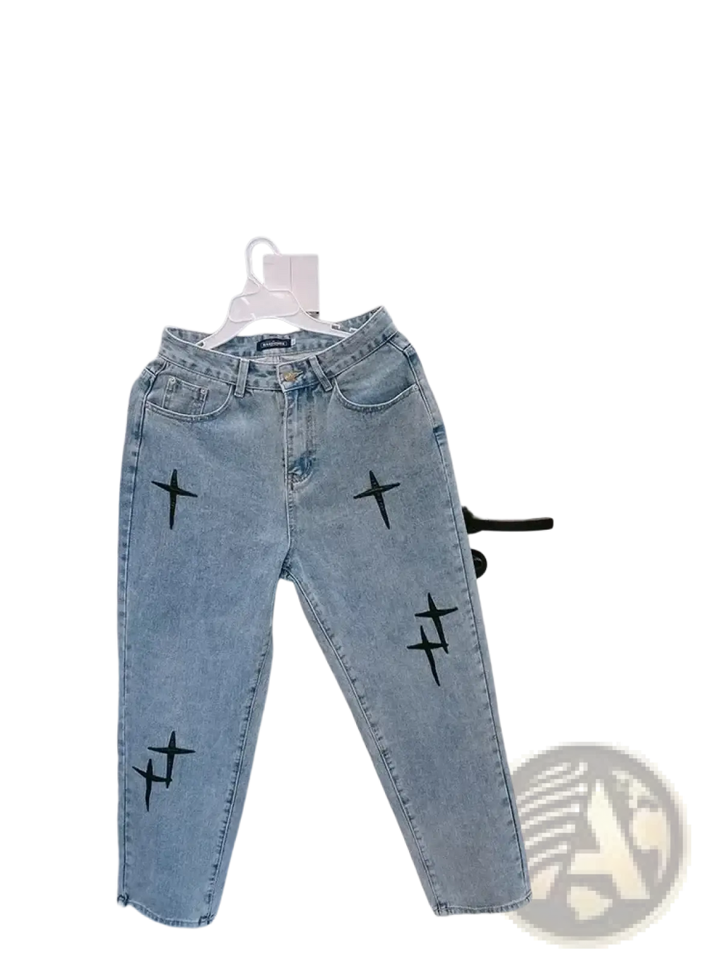 Light-wash denim baggy wide leg jeans with black cross embroidery on the legs in front view