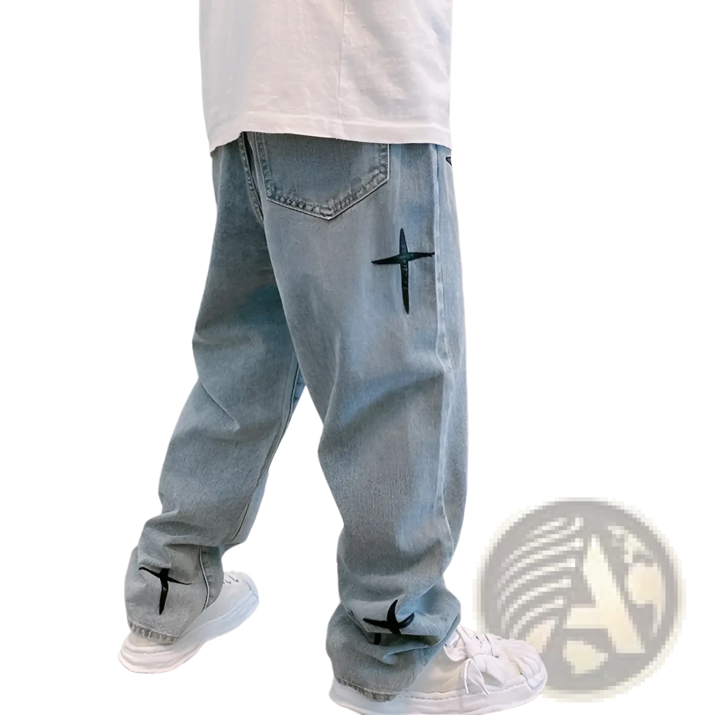 Back side of light-wash denim wide leg cargo pants with black cross embroidery on pocket and lower leg