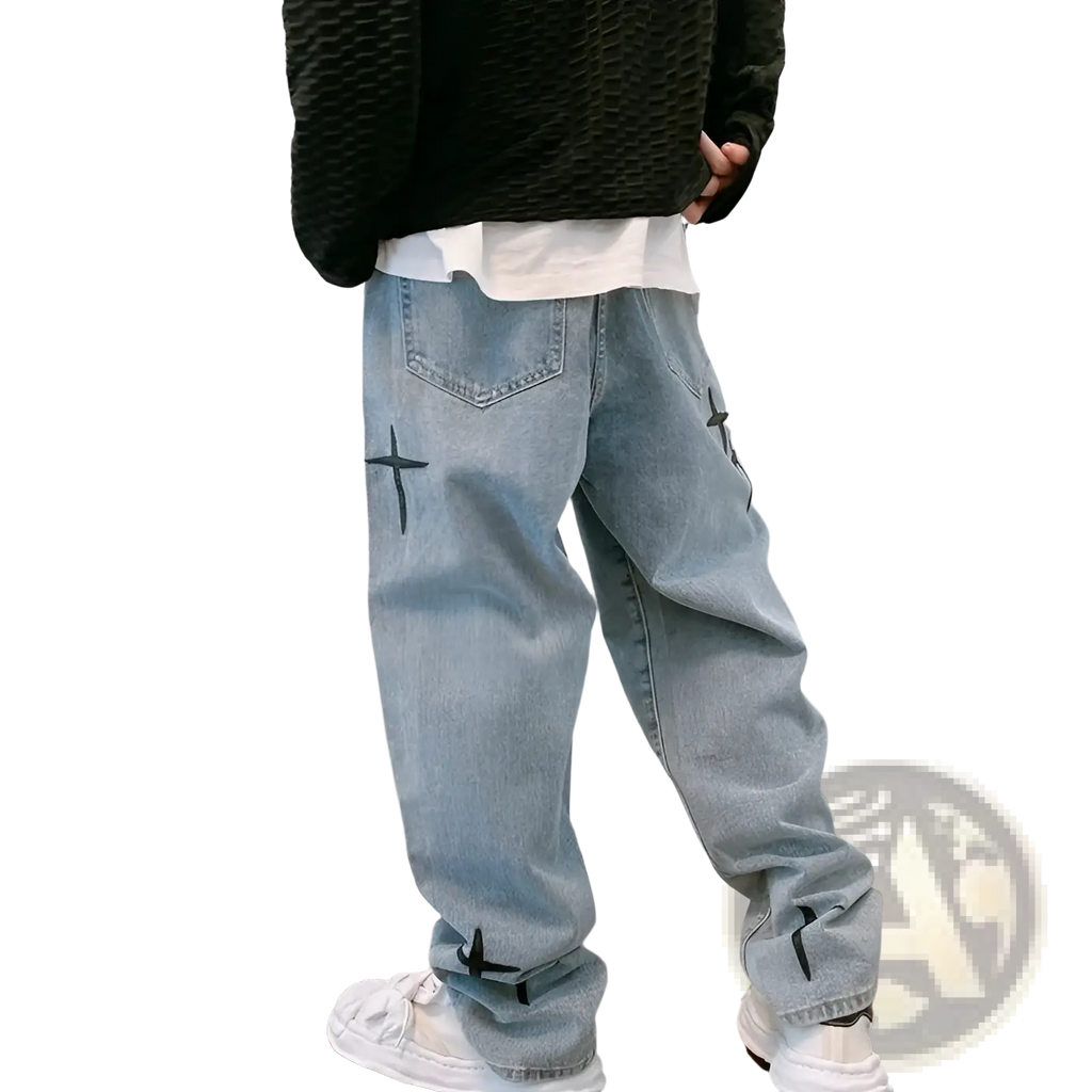 Back side of light-wash denim cross embroidered wide leg cargo pants with black embroidery on pockets and cuffs