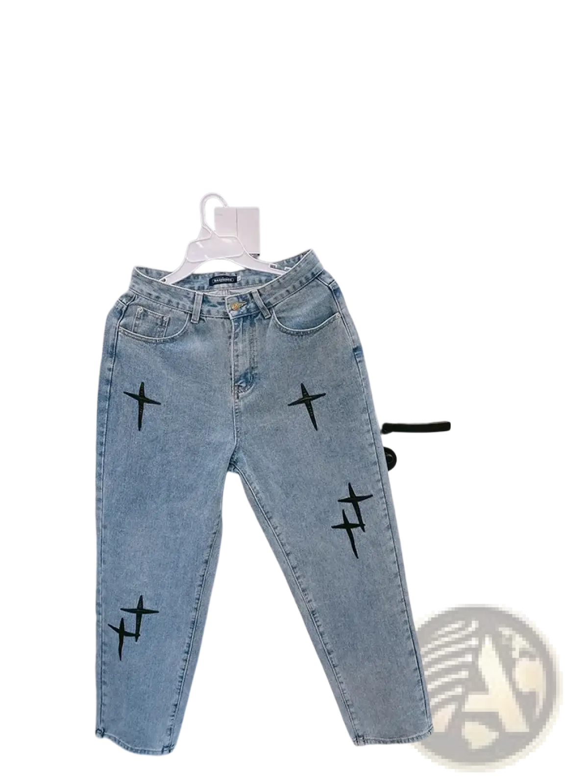 Light-wash denim cross embroidered wide leg cargo pants hanging on white hanger showing front side