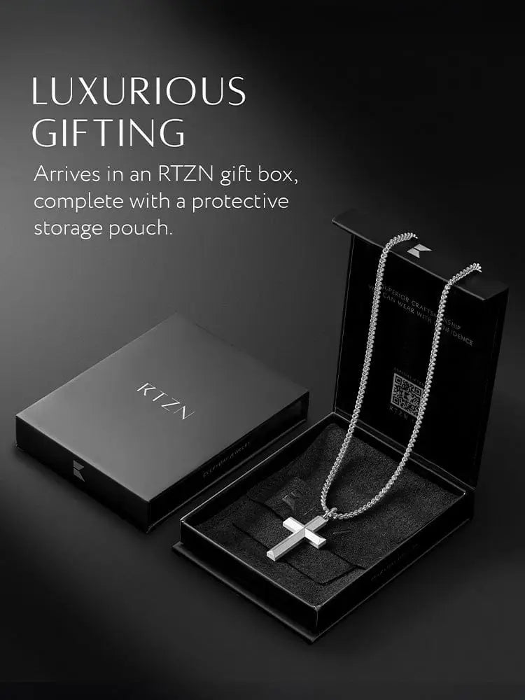 Geometric silver cross pendant with sleek polished finish on stainless steel curb chain necklace