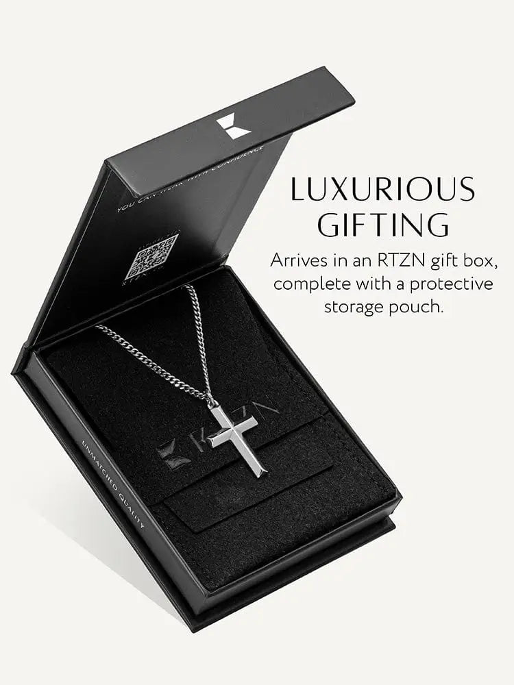 Geometric silver cross pendant on stainless steel curb chain displayed in an rtzn gift box