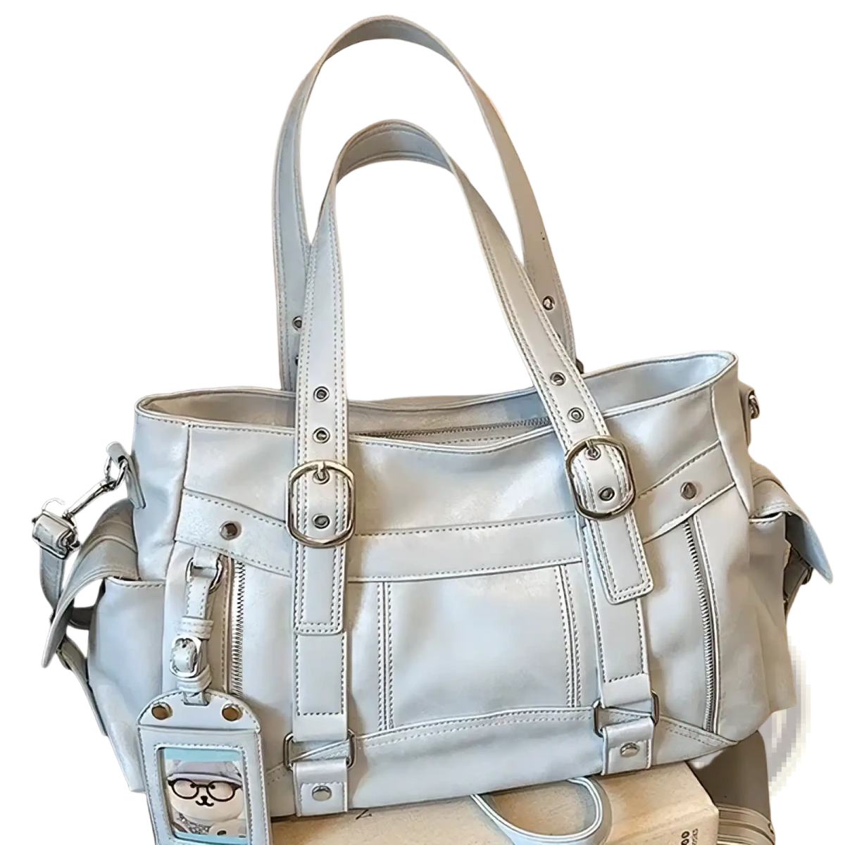 Light gray leather crossbody bag with large capacity silver hardware and cartoon cat charm for commuting use