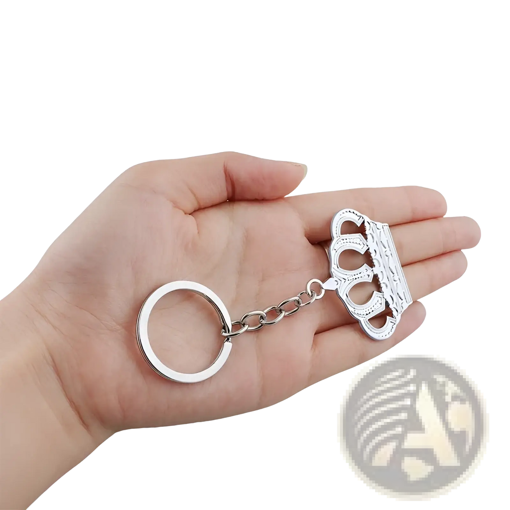 Silver metallic crown-shaped keychain with intricate detailing and chain link attached to a circular ring