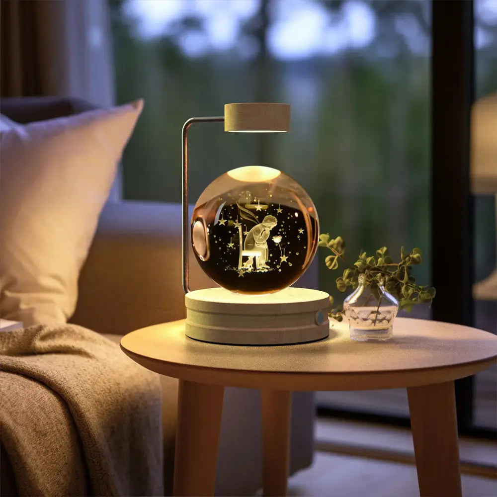 A warm glowing spherical 3d crystal ball usb bedside lamp with an engraved child and star scene