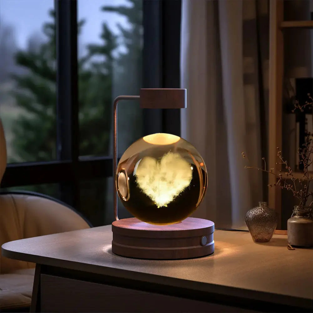 A glowing transparent spherical 3d crystal ball dinosaur night light with floating heart design on matte usb base