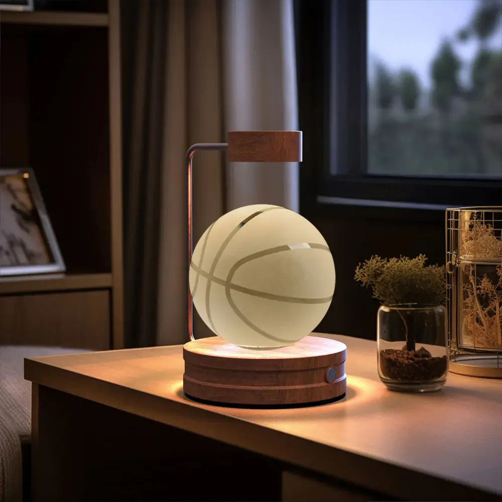 Floating basketball-shaped led lamp with matte white surface and gray lines levitating above wooden base in 3d crystal ball dinosaur night light usb bedside lamp
