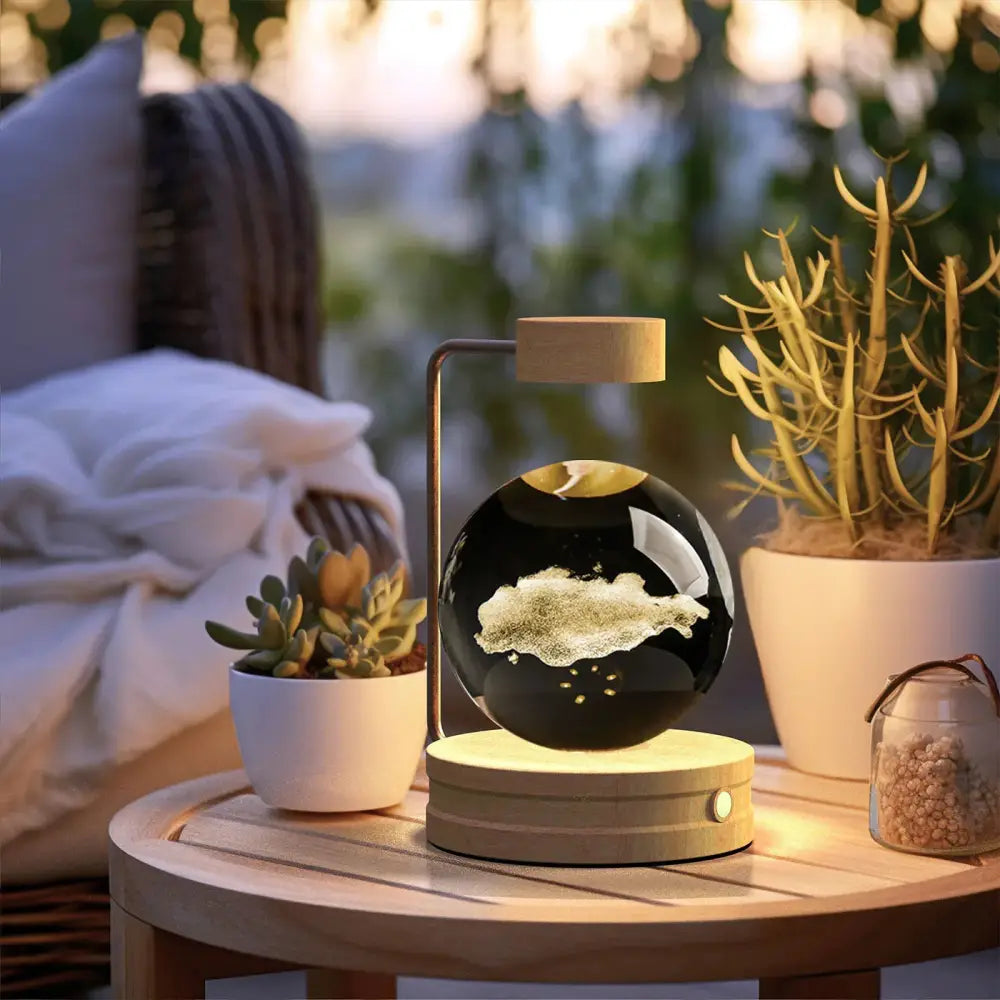 Floating black spherical globe with golden sand texture on minimalist wooden and metal stand 3d crystal ball dinosaur lamp