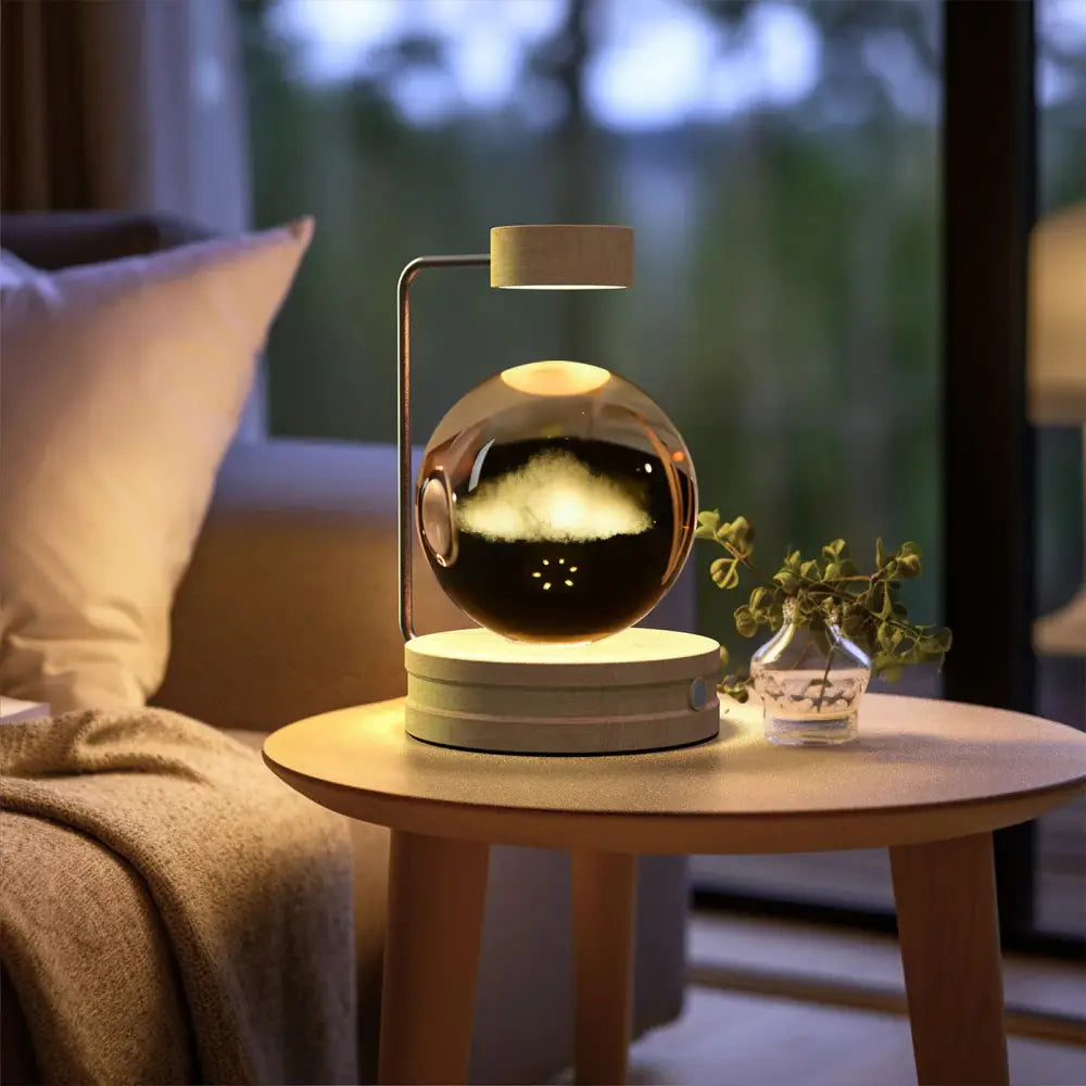 A sleek spherical magnetic levitation usb bedside lamp with reflective metallic finish and warm internal lighting