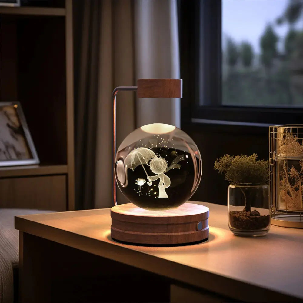 A glowing spherical glass 3d crystal ball dinosaur night light with laser-etched whimsical figure on wooden base