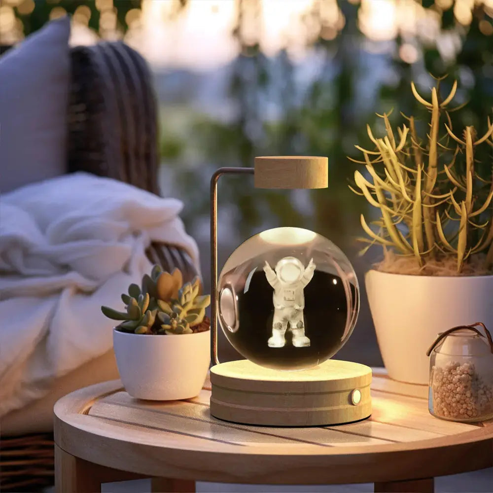 A sleek modern 3d crystal ball dinosaur night light with a clear glass sphere and wooden base usb bedside lamp