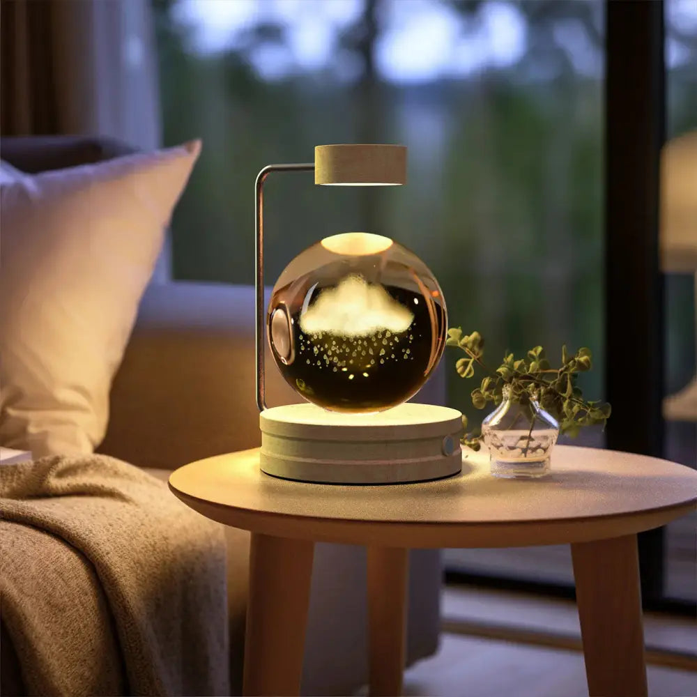 A sleek spherical 3d crystal ball dinosaur night light with metallic finish and illuminated cloud design USB lamp