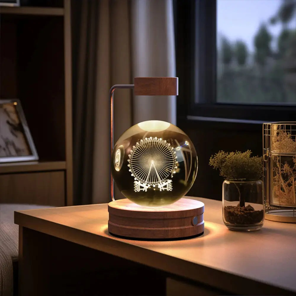 A warm-toned 3d crystal ball usb bedside lamp with a laser-engraved ferris wheel design on its transparent surface