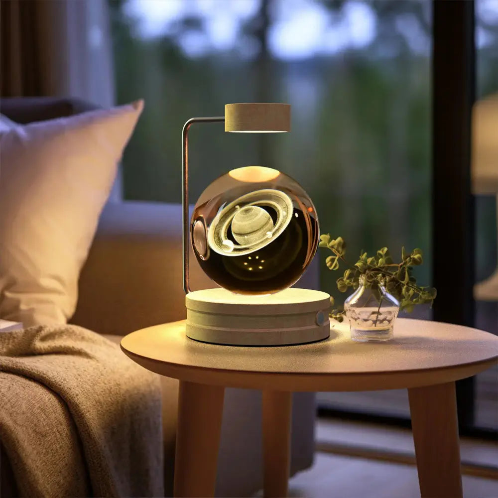 A sleek metallic 3d crystal ball dinosaur night light with saturn design illuminated by warm ambient lighting
