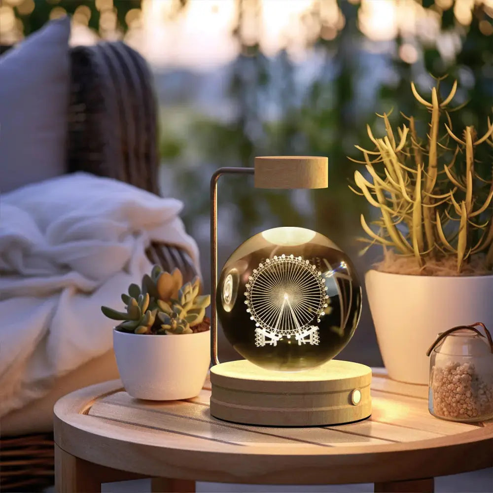 A sleek black spherical led lamp with an illuminated ferris wheel design etched on 3d crystal ball dinosaur night light