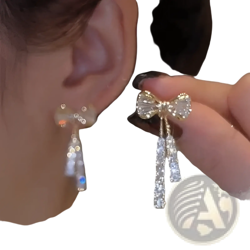 A gold crystal bow earring with clear crystals and dangling crystal strands from the crystal bow and pearl dangle earrings collection