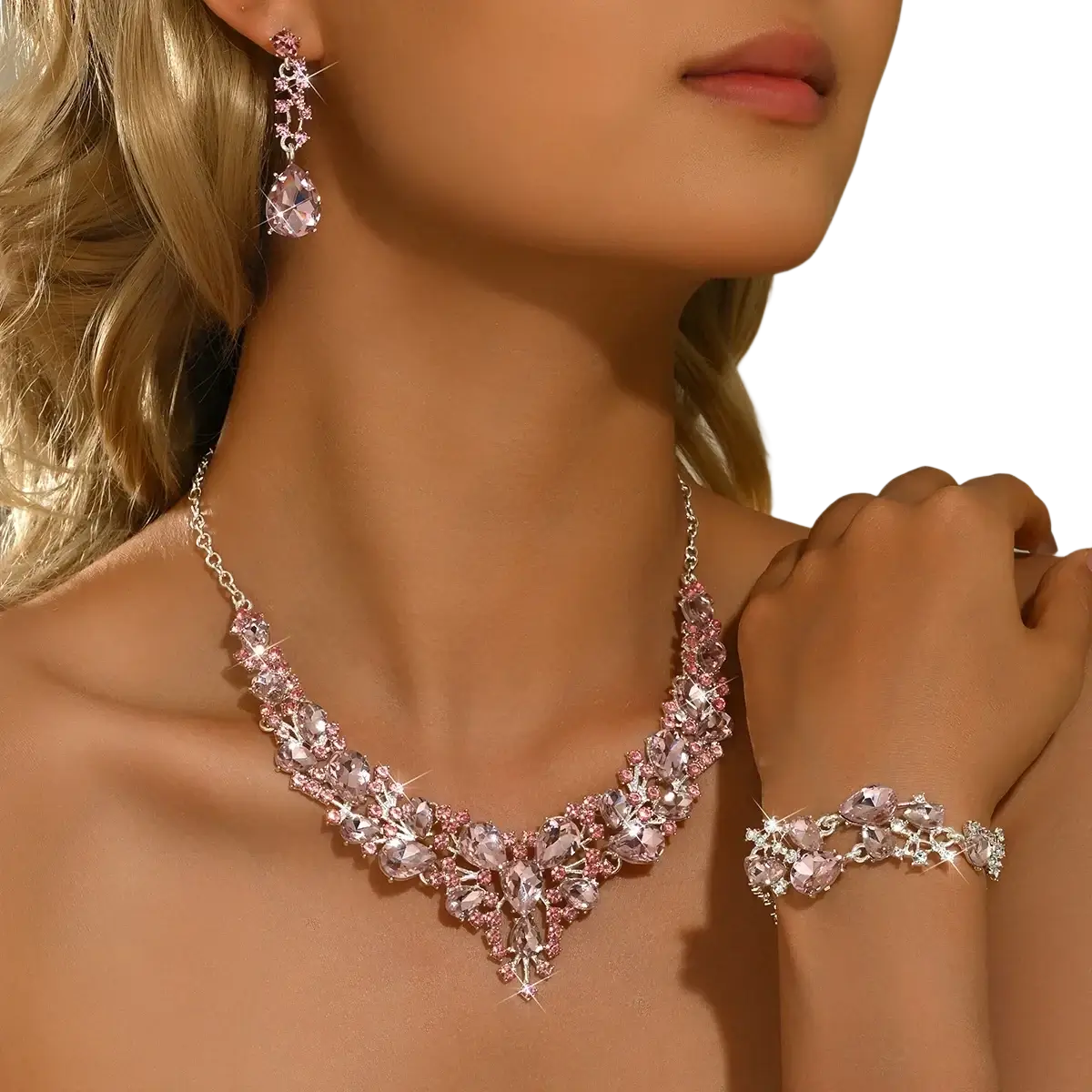 A sparkling pink and silver crystal bridal jewelry set with v-neck necklace, matching earrings, and delicate bracelet