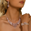A sparkling pink and silver crystal bridal jewelry set with v-neck necklace, matching earrings, and delicate bracelet