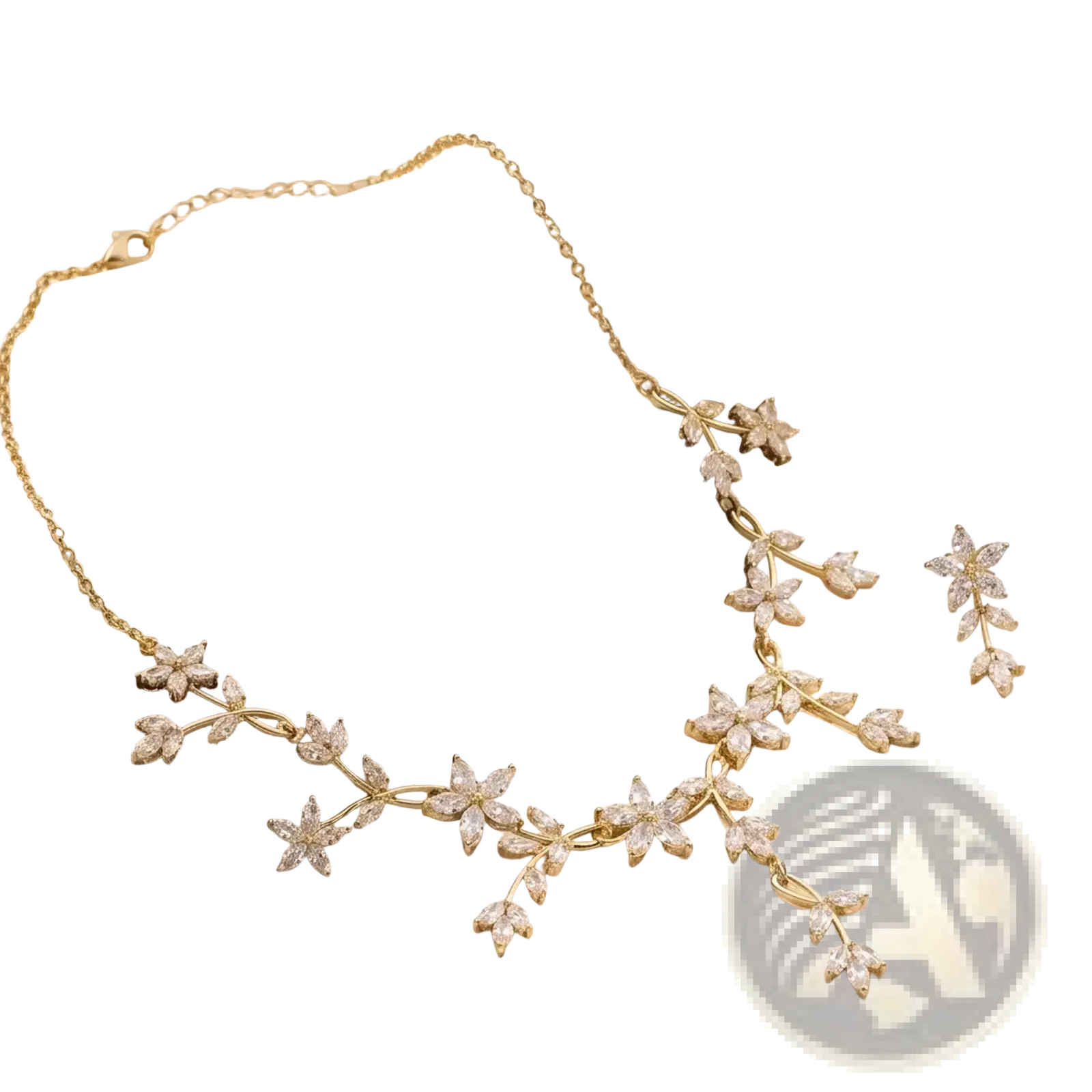 Crystal bridal necklace and earring set in gold tone with delicate floral and leaf motifs adorned with clear crystals