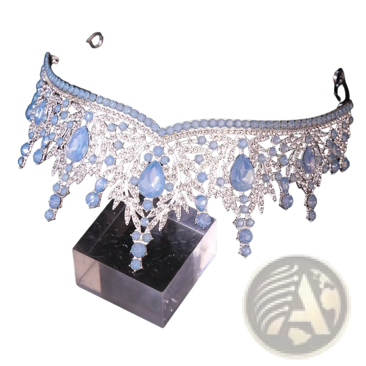 A delicate silver crystal bridal tiara crown with light blue teardrop gemstones and leaf filigree for wedding hair accessories