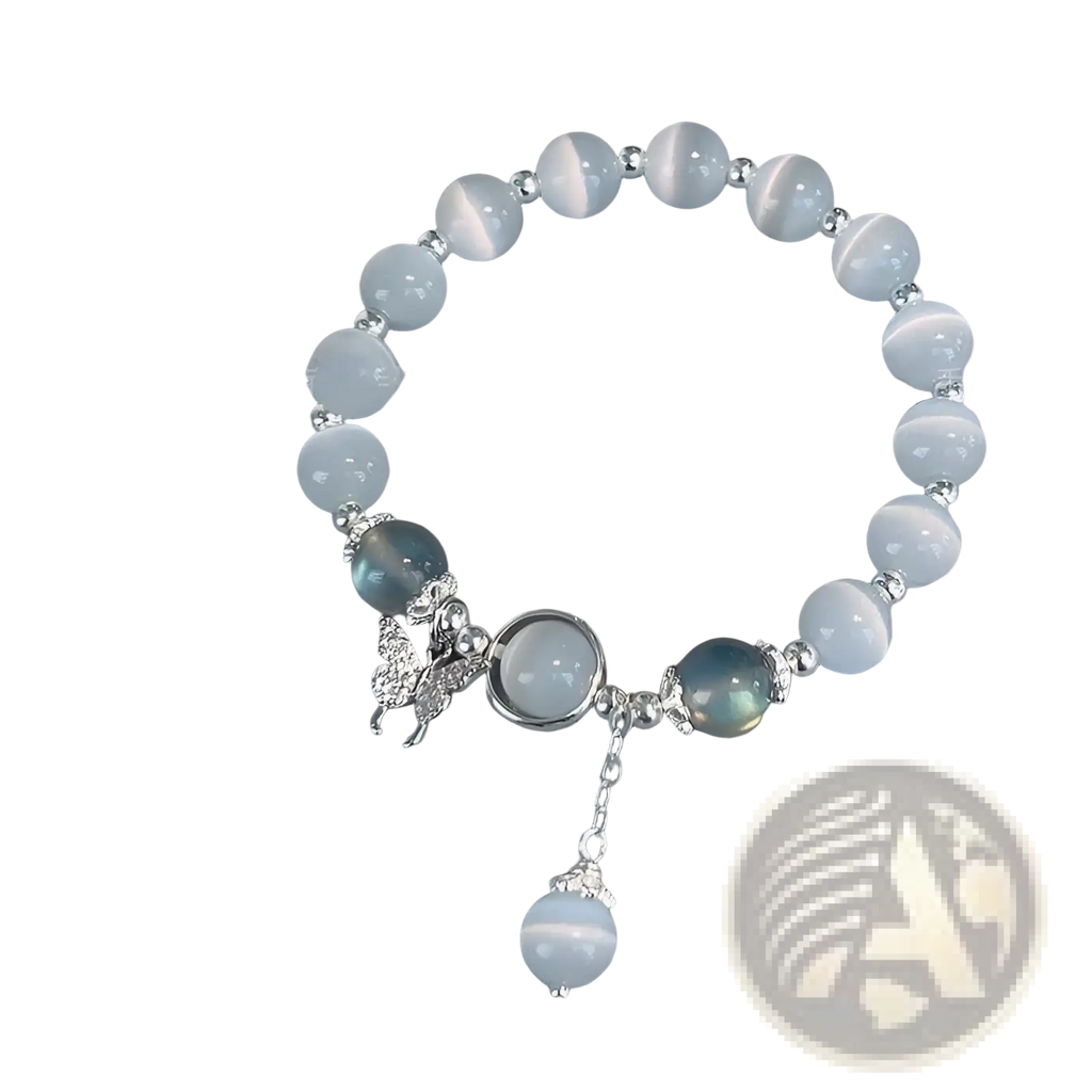 A delicate crystal butterfly cat’s eye bead bracelet with light blue stones silver accents and a butterfly charm