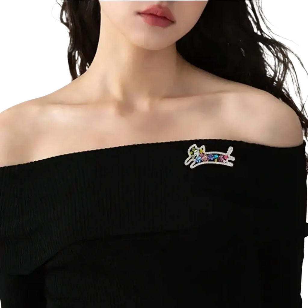 Colorful sparkling cat-shaped rose gold brooch with multicolored gemstones and silver outline rhinestone pin