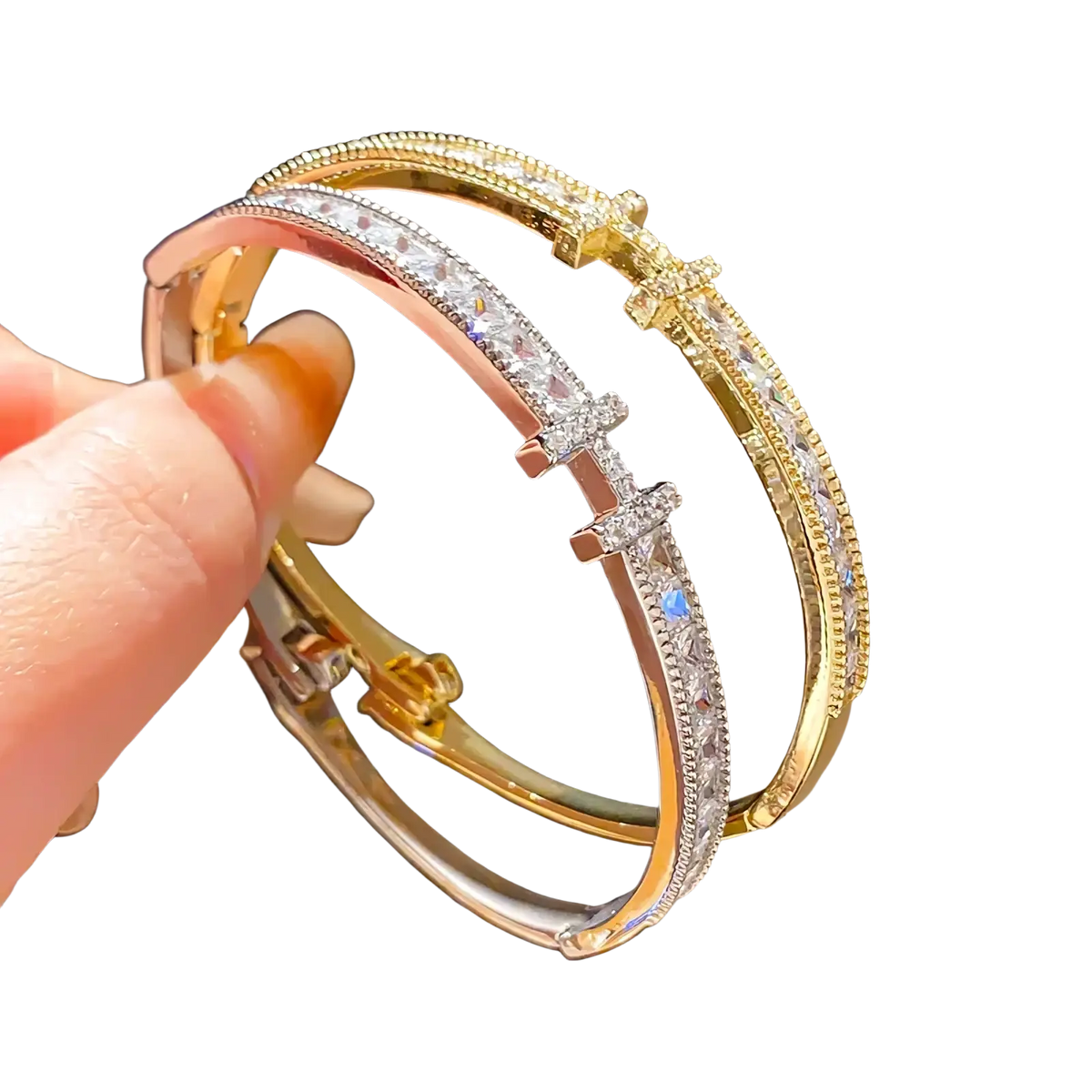 Crystal cross cuff bracelet featuring gold and rose gold bangles with clear crystal accents and cross clasp design