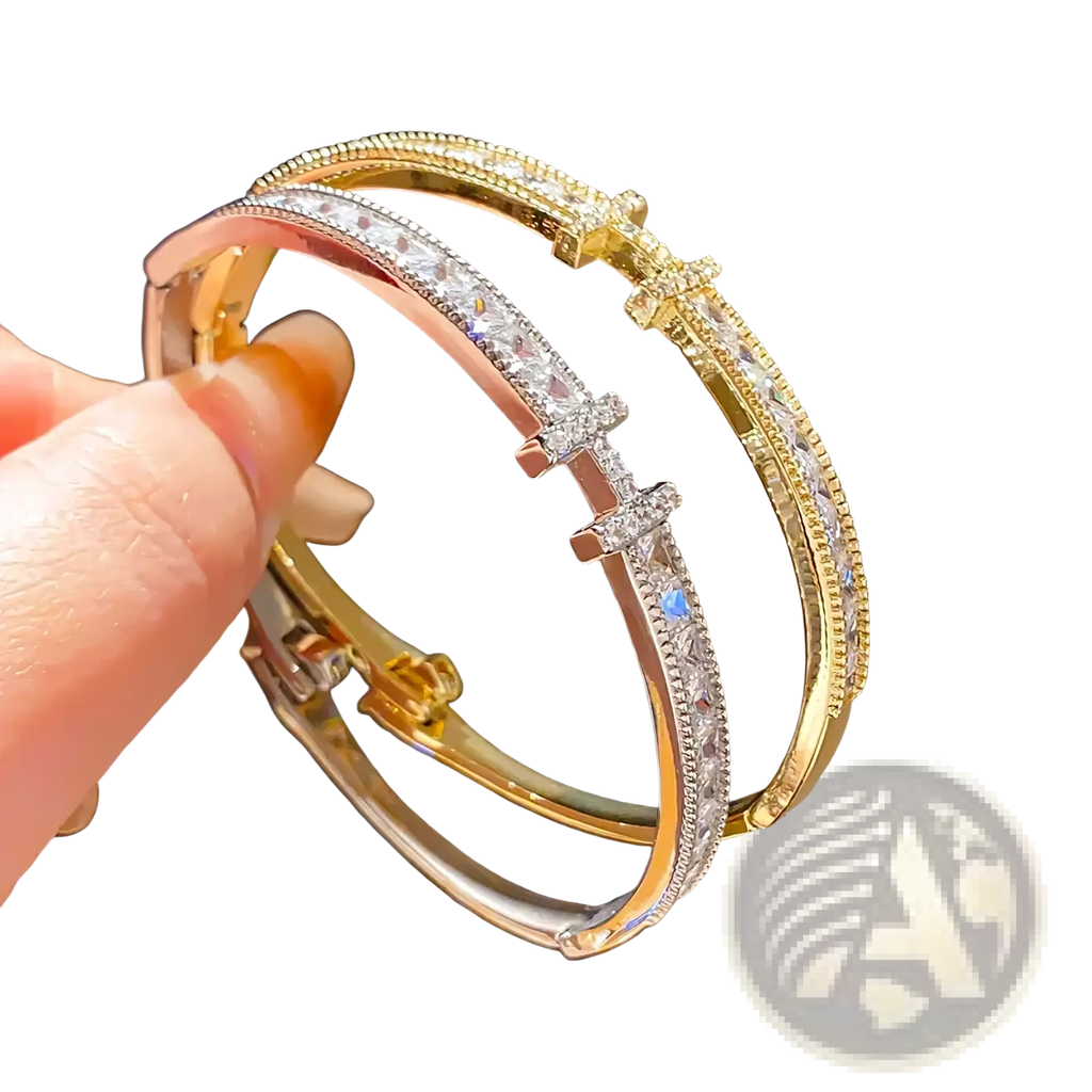 Crystal cross cuff bracelet featuring gold and rose gold bangles with clear crystal accents and cross clasp design