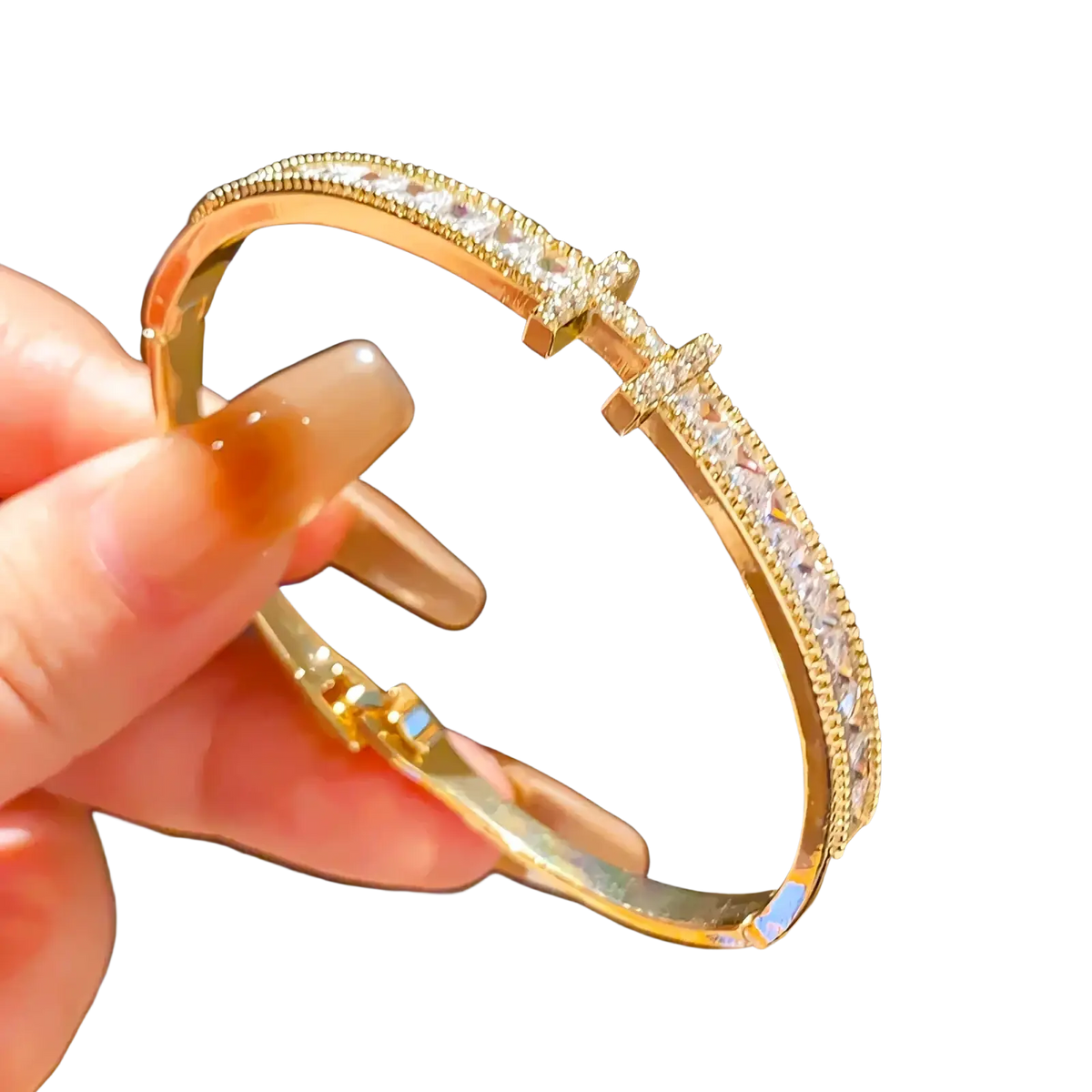 Gold-toned crystal cross cuff bracelet adorned with sparkling clear crystals and a central cross embellishment