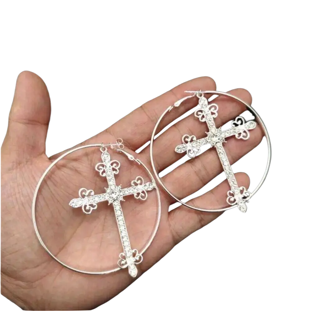 Silver hoop earrings with ornate cross charms featuring sparkling rhinestones and intricate filigree detailing