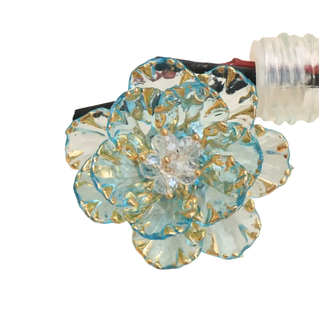 Crystal flower brooch with delicate light blue glass petals trimmed in gold and a clear crystal center fashion accessory