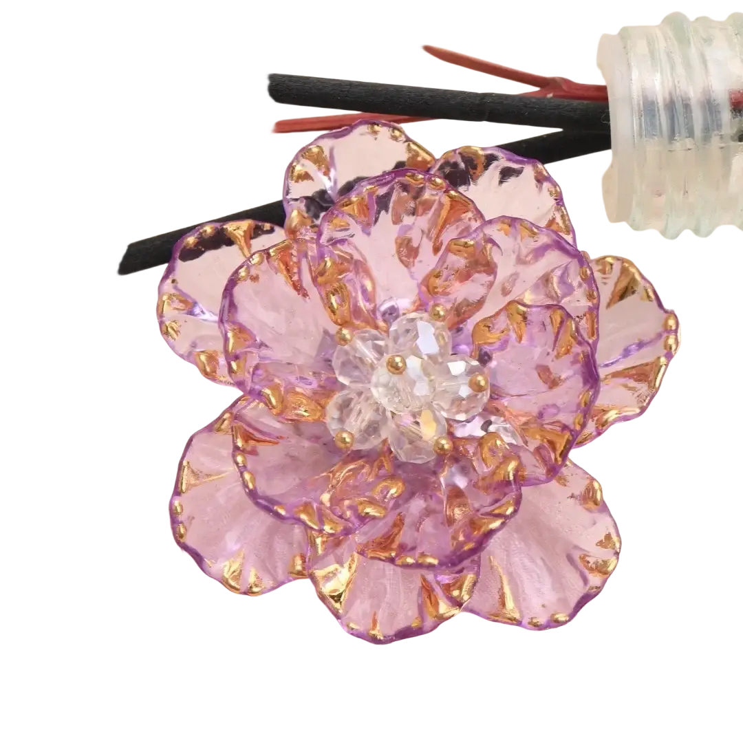 A delicate translucent purple glass flower brooch with gold-trimmed petals and a crystal center fashion accessory
