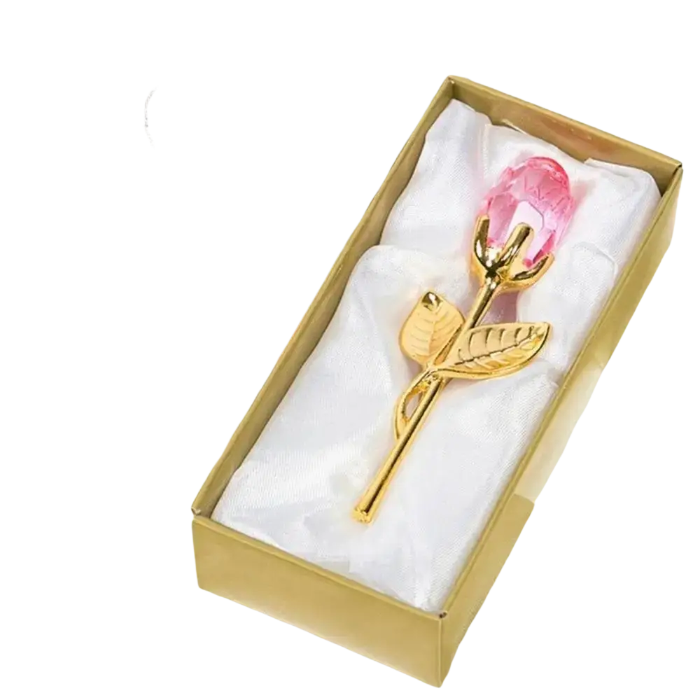 A delicate pink crystal glass rose with gold-toned metal stem and leaves in an elegant gift box for Valentine’s Day