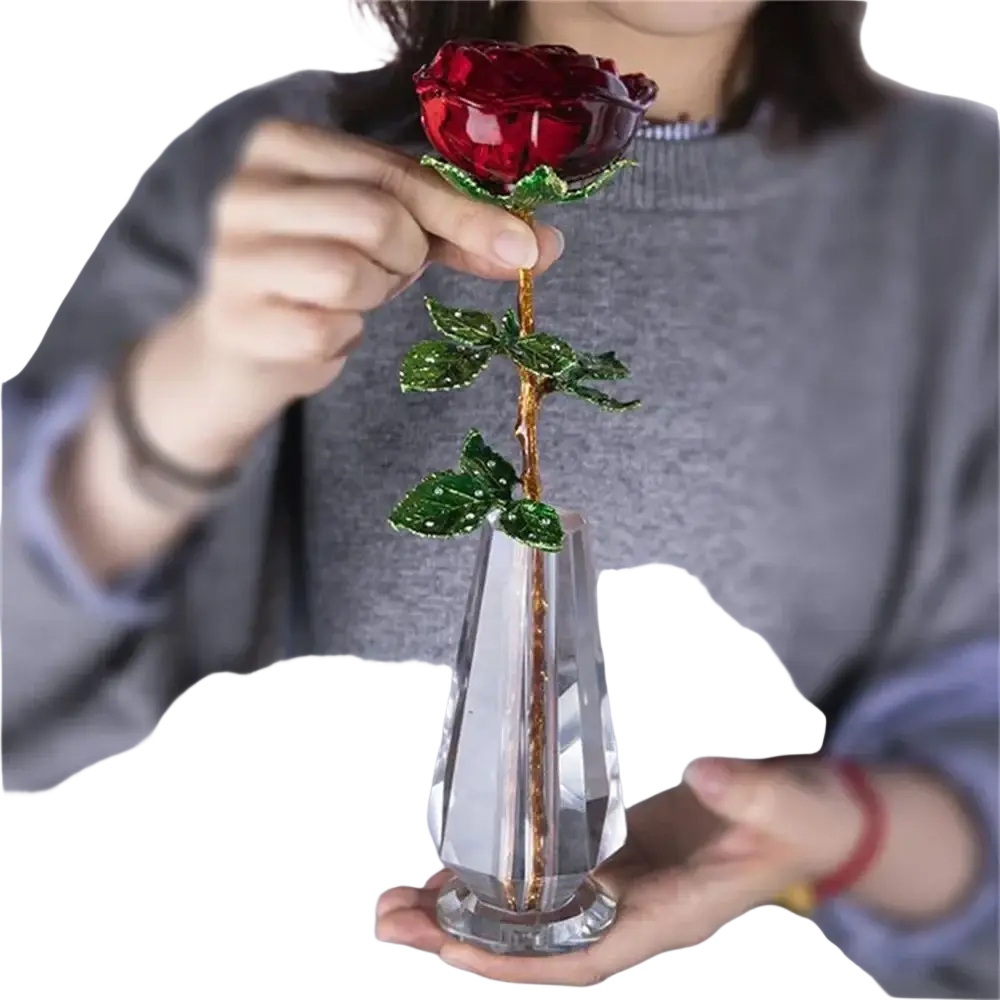 A crystal glass rose gift for Valentine’s Day with a sparkling red crystal flower green beaded leaves and a gold stem in a clear vase