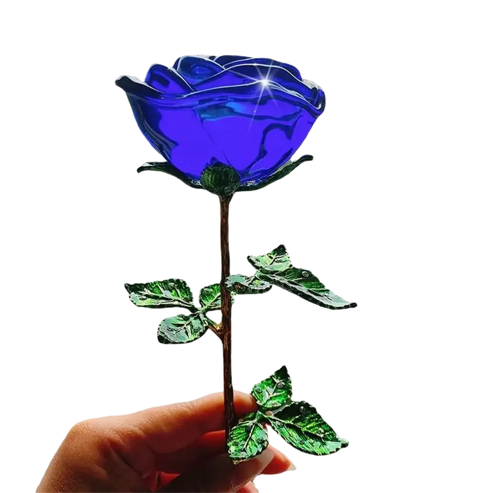 A vibrant blue crystal glass rose with metallic stem and green leaves held gently as a valentine’s day gift