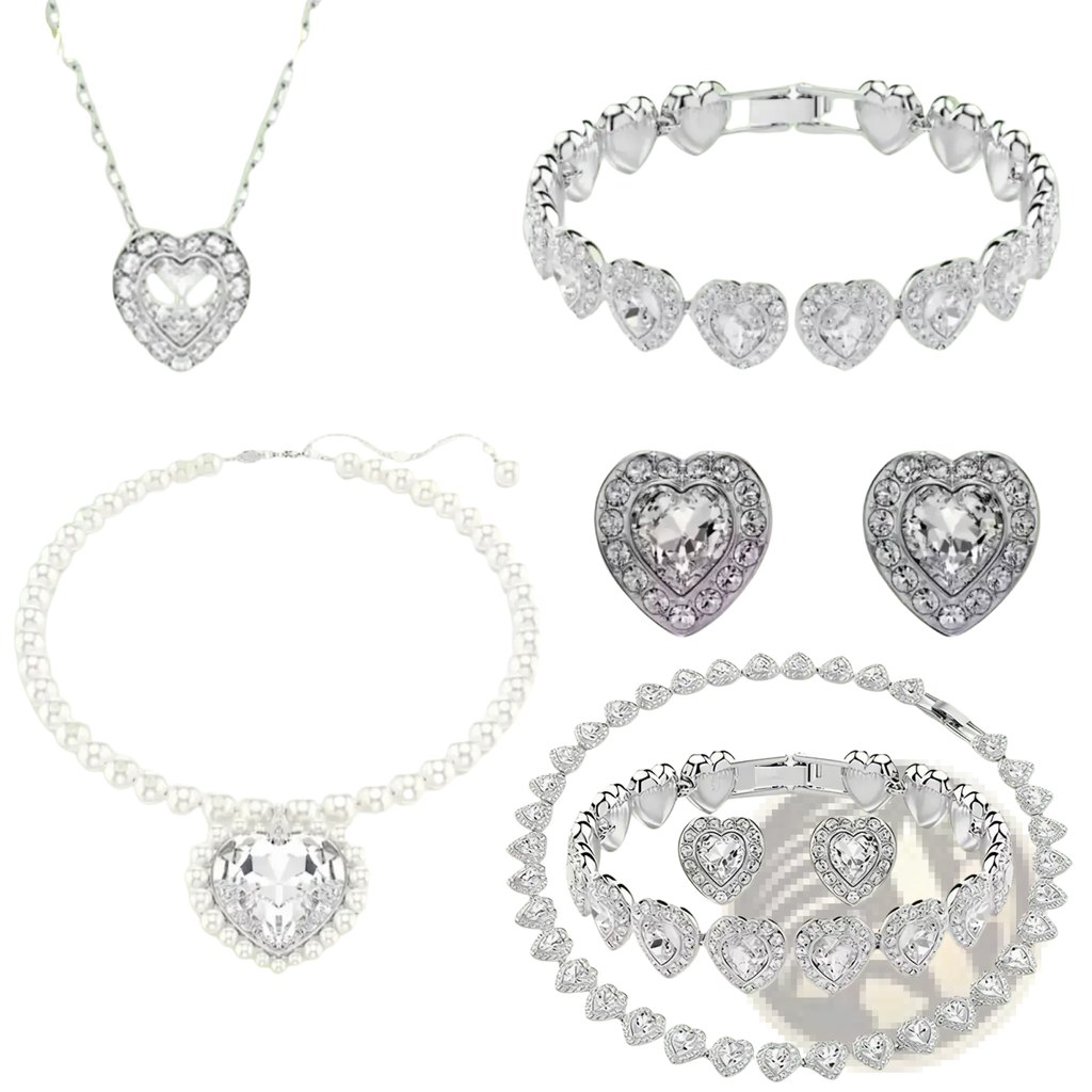 Silver heart-shaped jewelry set with sparkling crystals and delicate chain design including necklace earrings and bracelet