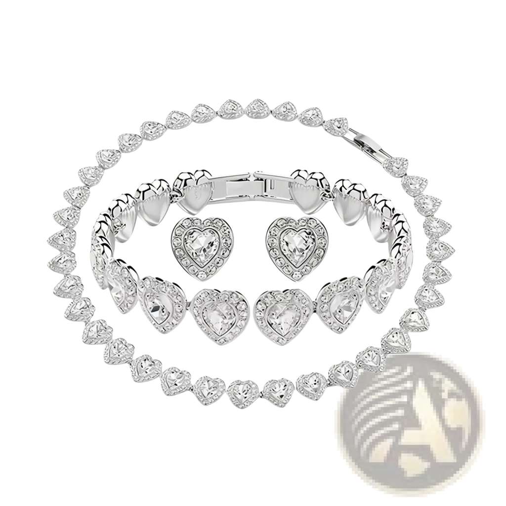 Silver heart-shaped jewelry set with sparkling crystal accents and polished metallic finish including necklace earrings bracelet