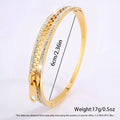 Gold-toned crystal interlocking titanium steel zipper bangle bracelet with textured chain and clear crystal edging