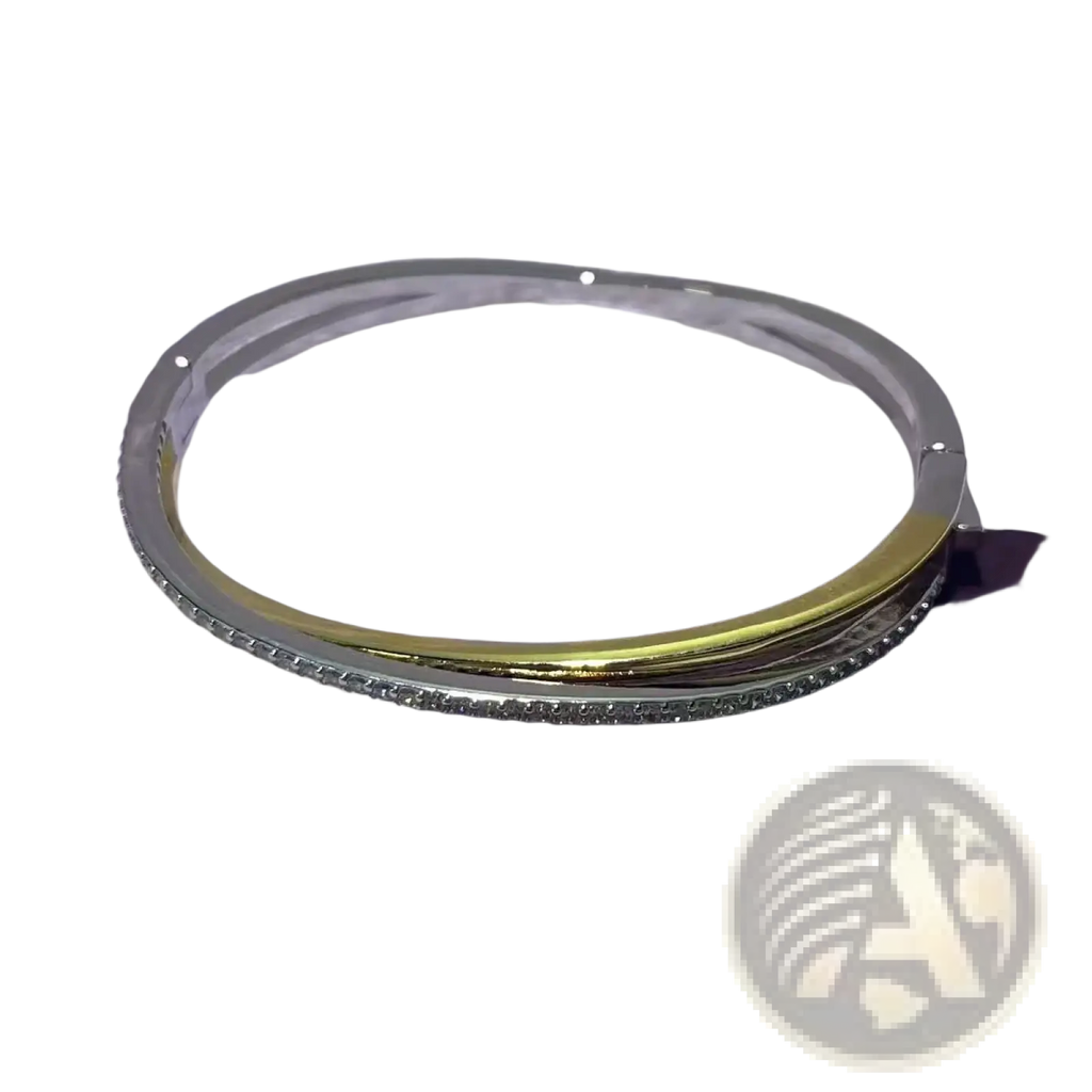 A sleek two-tone bangle with polished silver outer band gold-toned inner layer and clear stones from crystal jewelry set