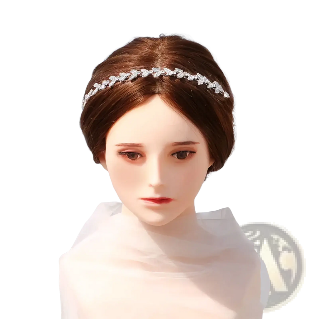 A delicate silver crystal leaf bridal headband adorned with sparkling rhinestones as a wedding hair accessory