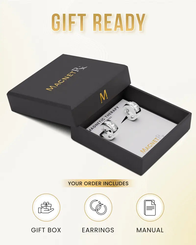 Silver crystal magnetic therapy huggie earrings in a sleek black gift box for stylish healing benefits