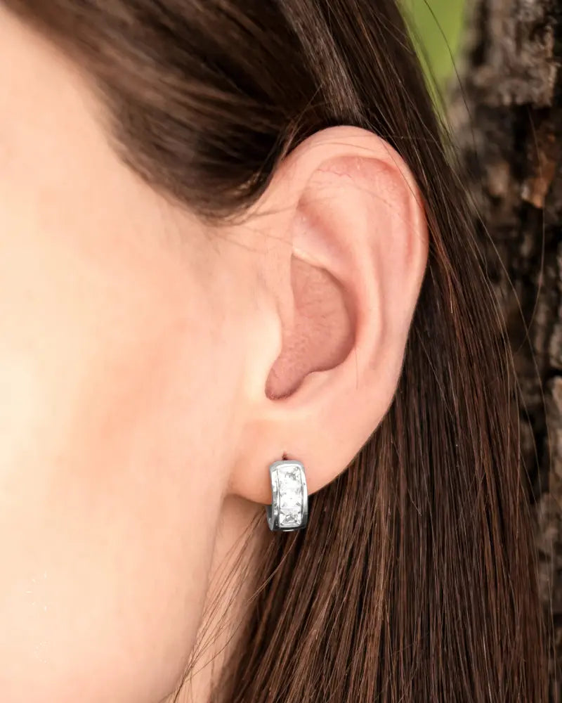 Silver crystal magnetic therapy huggie earrings with rectangular silver hoops embedded with clear stones